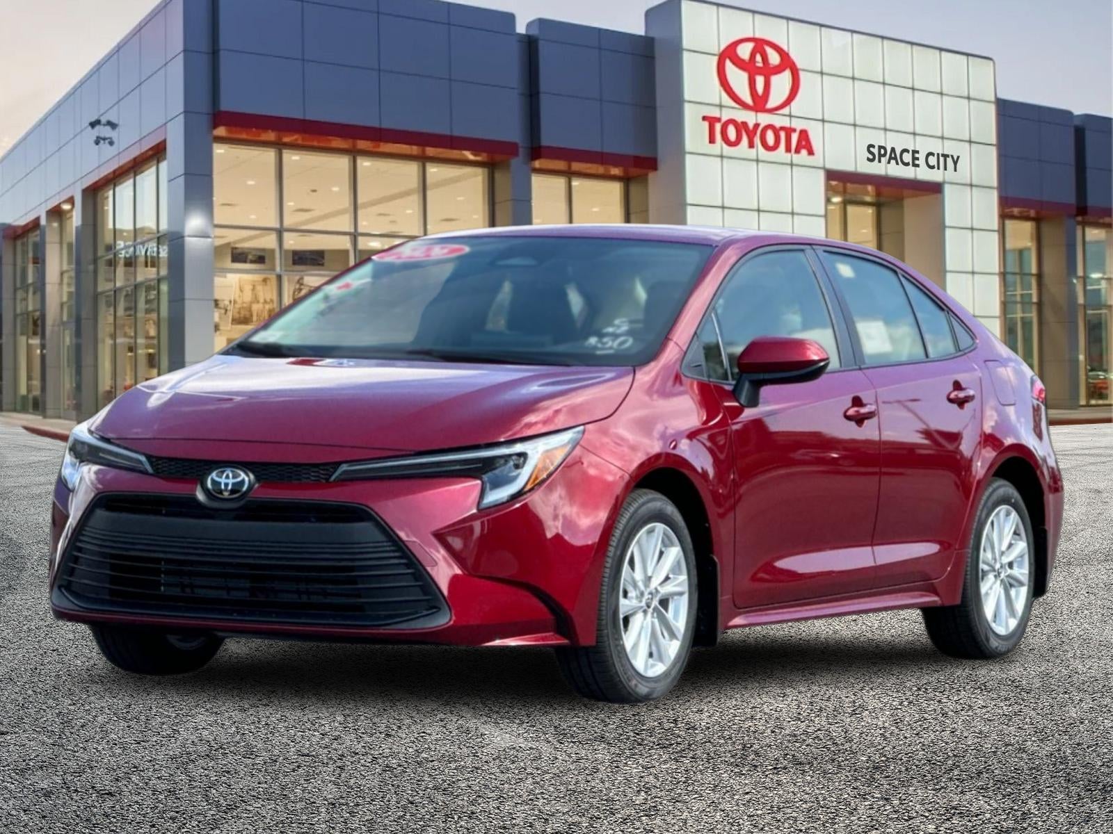 2026 Toyota Corolla Hybrid LE in Ruby Flare Pearl — front three-quarter view